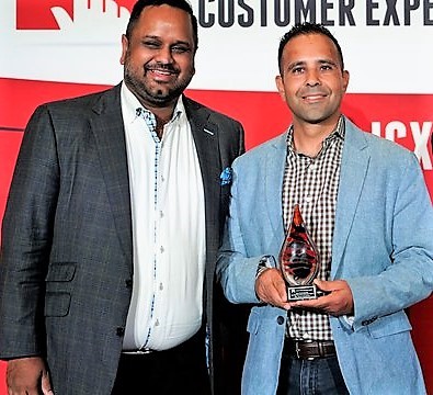 Rishi Gupta and Rafik Hanna accept the ICX award for the Taco Bell self-order kiosk